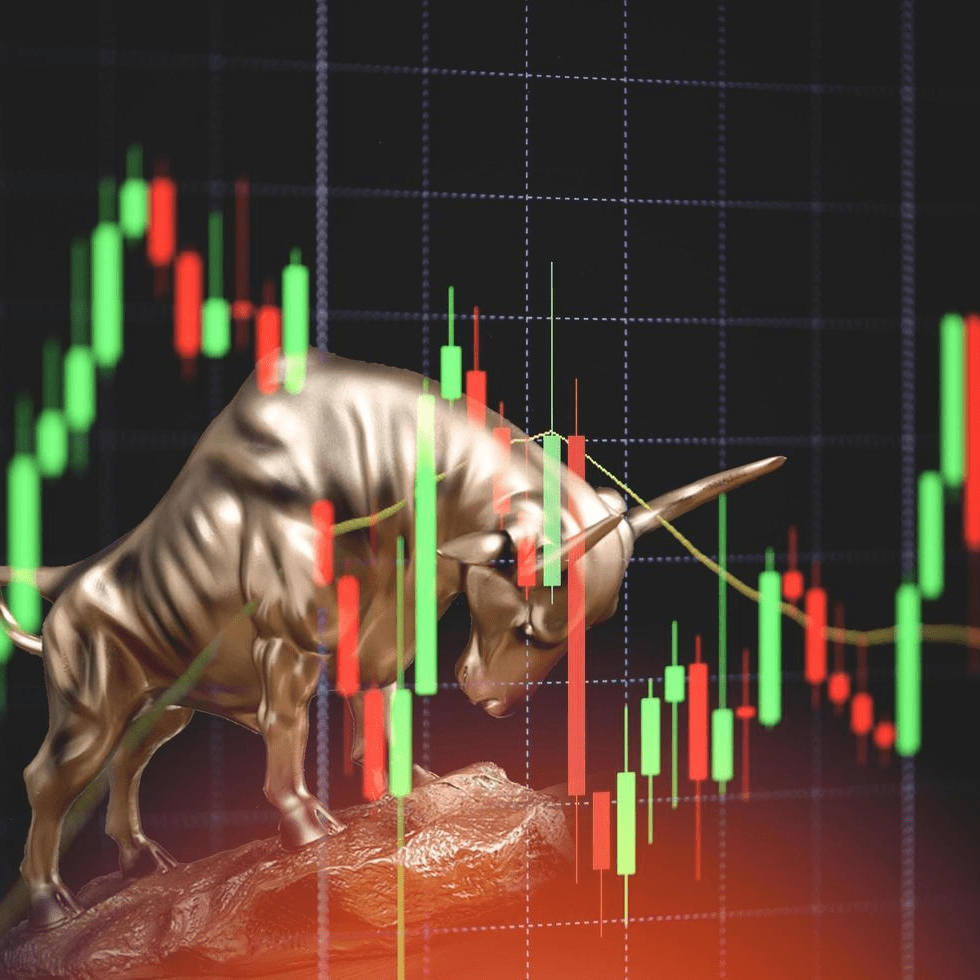 Golden bull statue symbolizing a bullish market trend with rising stock chart and candlestick graph in the background.